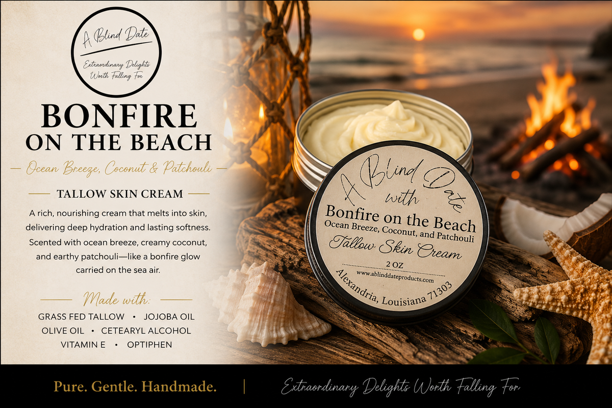 Luxury Bonfire on the Beach Tallow Skin Cream by A Blind Date displayed on driftwood beside seashells at a sunset beach bonfire. Handmade tallow skin cream scented with ocean breeze, coconut, and patchouli, creating a warm coastal atmosphere while deeply moisturizing and nourishing the skin.