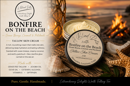 Luxury Bonfire on the Beach Tallow Skin Cream by A Blind Date displayed on driftwood beside seashells at a sunset beach bonfire. Handmade tallow skin cream scented with ocean breeze, coconut, and patchouli, creating a warm coastal atmosphere while deeply moisturizing and nourishing the skin.