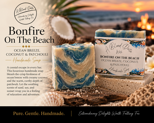 A Blind Date Bonfire on the Beach handmade soap with blue and cream swirls, displayed with coconut, seashells, driftwood, and a glowing beach bonfire at sunset.